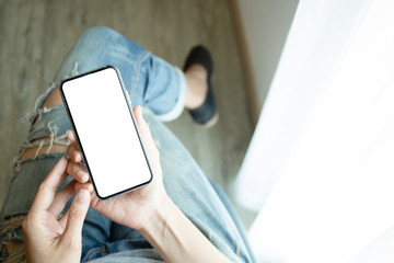 Mockup image blank white screen cell phone.man hand holding texting using mobile sitting at coffee shop.background empty space for advertise text.people contact marketing business,technology 