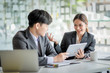 © amnaj - Group of modern business people are talking and smiling at the meeting. Asian business groups discussed investment and business planning at the meeting.