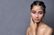 Closeup portrait of an Indian model with bold eye makeup and lipstick looking at camera. Makeup portrait for eye makeup and lipstick.