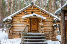 Log House In The Winter In The Forest.Wooden Structure For Relaxing Among The Trees.