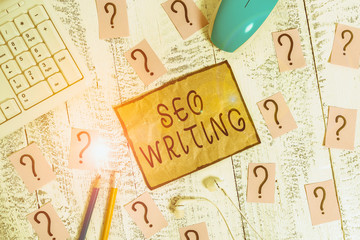Poster - Conceptual hand writing showing Seo Writing. Concept meaning grabbing the attention of the search engines using specific word Writing tools and scribbled paper on top of the wooden table
