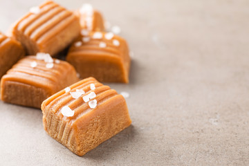 Salted caramel on light grey table, closeup. Space for text