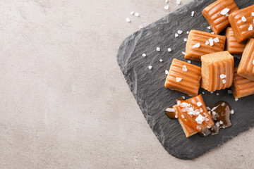 Wall Mural - Salted caramel on light grey table, top view. Space for text
