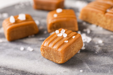 Salted caramel on marble table, closeup view