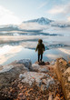 © Maximilian - man enjoys the perfect nature view of the winter lake and mountains.