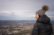 © Juan Alberto Ruiz/ADDICTIVE STOCK - Back view of smiling Asian woman in knitted hat with pompom and warm jacket enjoying city in amazing place in San Marino, Italy