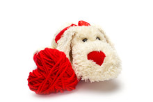 Red Knitted Heart And Plush Fluffy Little Dog With A Red Nose For Valentine's Day On A White Background, Isolate .close Up