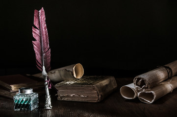 Wall Mural - Quill pen and a rolled papyrus sheet on a wooden table with old books