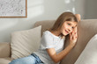 © New Africa - Cute little girl on couch at home