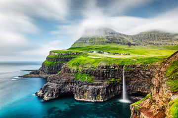 Wall Mural - Incredible day view of Mulafossur waterfall in Gasadalur village, Vagar Island of the Faroe Islands, Denmark. Landscape photography