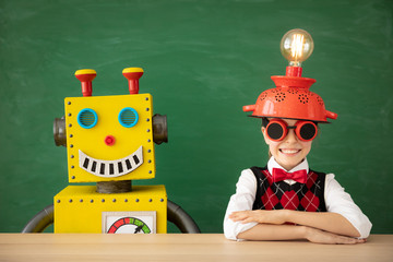 Canvas Print - Happy child with toy robot in school