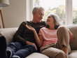 © Westend61 - Happy senior couple relaxing on couch at home