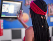 © Westend61 - Young woman with braided hairstyle checking the orders on a screen