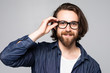 © F8  \ Suport Ukraine - Portrait of handsome young bearded man in glasses on gray background.