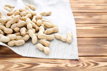 Poster - Peanuts with napkin on brown wooden table