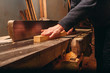 © Iaroslav - Young carpenter making wooden parts for the production of wooden furniture, joiner's shop work.