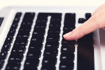 Poster - Female hand typing on laptop keyboard