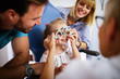 © NDABCREATIVITY - Ophthalmologist is checking the eye vision of little cute girl in modern clinic.