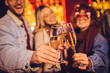 © minastefanovic - Close view of group of happy friends drinking champagne and celebrating New Year at the street. New year party.