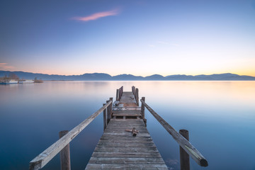 Naklejka na meble Wooden pier or jetty and lake at sunrise. Torre del lago Puccini Versilia Tuscany, Italy