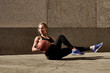 Fitness woman working out at outdoors gym using medicine ball. Sportswoman stretching outdoors with medicine ball. Copyspace for text