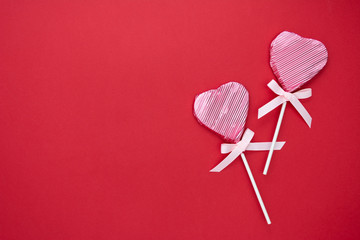 Love, Valentine's Day mock up, flat lay, pink lollipop in the shape of a heart isolated on red background, copy space.