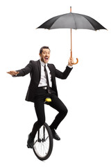 Sticker - Businessman riding a unicycle and holding an umbrella