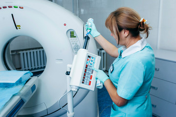 Doctor prepares automatic dual shot syringe for high tech ct scanner