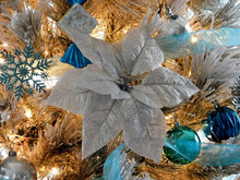 Silver Christmas Flower With Ornaments In A Christmas Tree