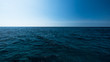 Dark and blue open sea with blue sky