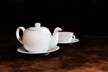 White porcelain tea cup and teapot, English tea on table, Afternoon Tea