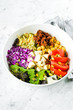 Vegetarian buddha bowl. Raw vegetables, tofu and bulgur in white bowl. Vegetarian, healthy, detox food concept