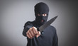 © andranik123 - Man in black balaclava threatening with knife.