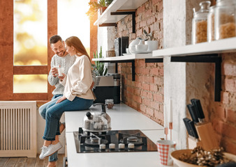 Canvas Print - Happy couple drinking milk in kitchen