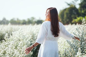 Wall Mural - Portrait image of an asian woman in a beautiful Cutter flower field