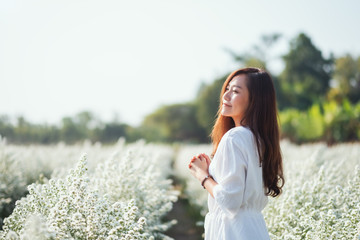 Wall Mural - Portrait image of an asian woman in a beautiful Cutter flower field