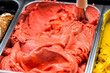 Macro closeup of strawberry flavor red pink sorbet gelato ice cream with swirl scoop on display in cafe store shop in famous Florence Italy Firenze Centrale Mercato
