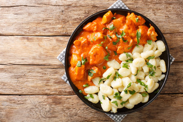 Wall Mural - Hungarian Chicken Paprikash features tender braised chicken and a tangy sauce spiced with paprika closeup on a plate. Horizontal top view