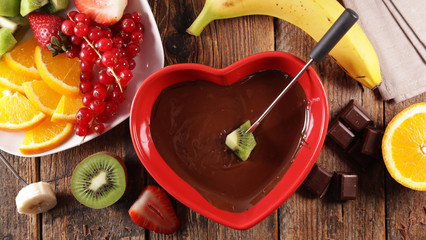 Wall Mural - chocolate fondue with fresh fruit in red heart bowl