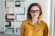 © contrastwerkstatt - Smiling young businesswoman wearing glasses