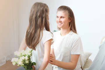 Mother's day concept. Mom and daughter at home