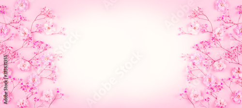 Spring floral composition made of fresh pink flowers on light pastel background