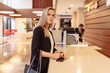© Rithor - Young independent nice girl takes Bank loan. Business woman opens savings account in Bank, receives money, makes cash transfer, money order. Good customer service. Female model makes mortgage