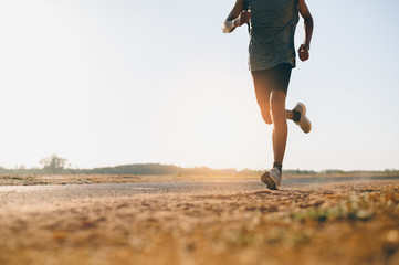 athlete runner feet running on road, jogging at outdoors. man running for exercise.sports and health