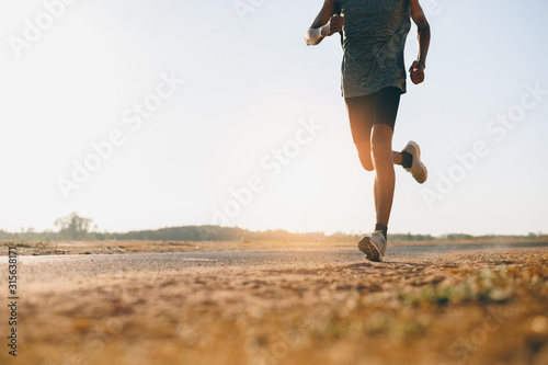 Cuadros en Lienzo Athlete runner feet running on road, Jogging at outdoors
