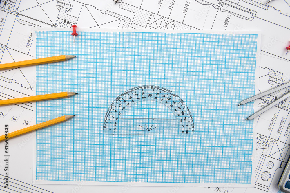 Technical drawing, graph paper and tools. Engineer office team working ...