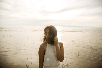 Woman in white dress on beach