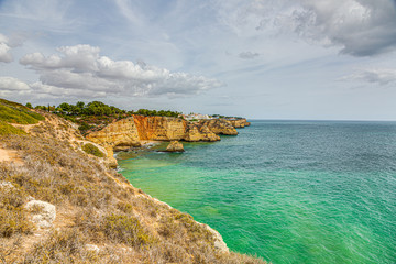 View on typical cliffy beach at Algarve coastline in Portugal in summer