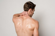back view of man having neck pain isolated on grey