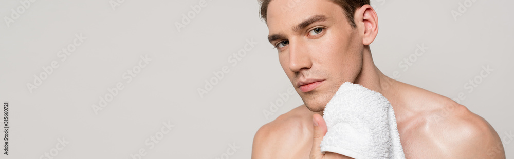 sexy man with muscular torso holding cotton towel isolated on grey, panoramic shot - obrazy, fototapety, plakaty 